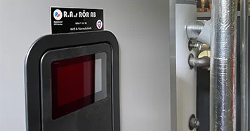 Bergvärmepump med en skärm på och rör runt omkring i omgivningen